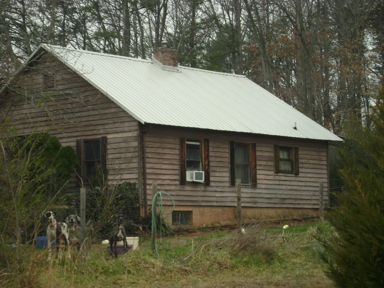 White metal roof on an old wood sided farmhouse, from a Metal Roof Installation job in Emlenton